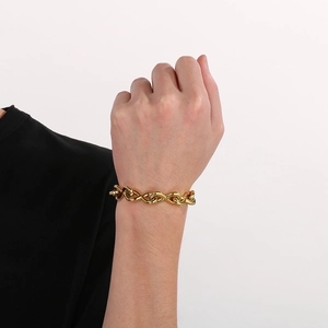 Golden chunky chain bracelet with interlocking infinity symbol links on a model's wrist