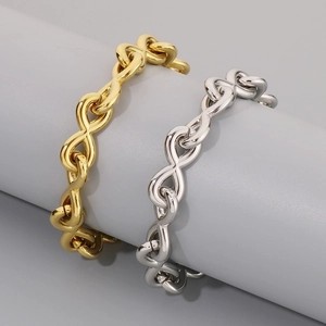 Infinity symbol chain bracelet in gold and silver finish on a display stand