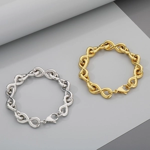 Detail showing infinity symbol charm bracelets in polished gold and silver steel finish
