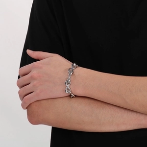 Detailed view of silver infinity symbol links on a stainless steel bracelet worn on wrist