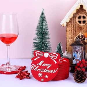 Close-up of red felt Christmas coasters featuring snowflake patterns and holiday wine setting