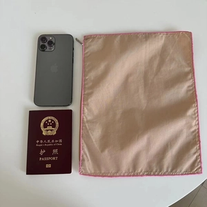 Detail view of khaki nylon organizer pouch with pink stitching and silver zipper