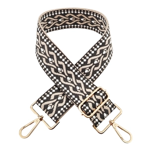 Detail of 5cm wide jacquard strap with black and white geometric pattern and gold hardware