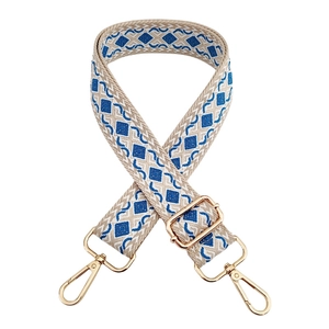 Detail of blue and beige geometric diamond jacquard bag strap with gold metal hooks