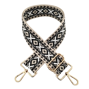 Close-up of geometric diamond pattern fabric strap with gold metal lobster clasps