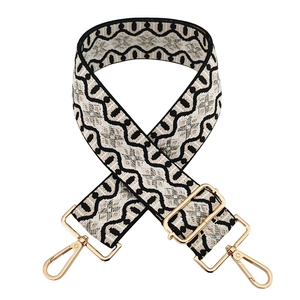 Adjustable wide shoulder strap with black and white geometric wave pattern and gold hooks