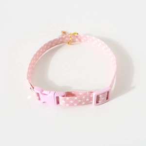 Detailed view of adjustable pink star pattern pet collar with golden bell and plastic buckle