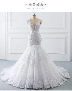 Close-up of luxury white mermaid wedding dress with intricate lace and sequin embroidery