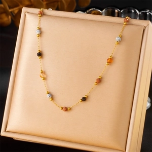 Gold stainless steel beaded necklace with colorful stones in a jewelry display box