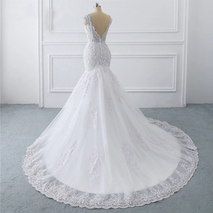 Elegant white mermaid wedding dress with lace embroidery, long train, and open back detail