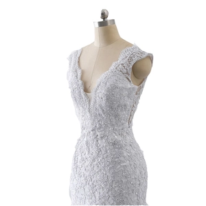 Luxe white mermaid wedding dress with deep V-neck, lace embroidery, and sequins