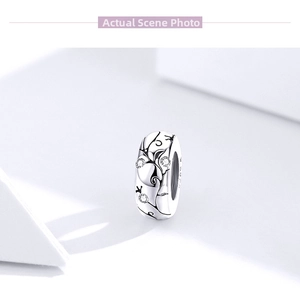 Close-up of S925 sterling silver charm bead with floral patterns and zircon stones