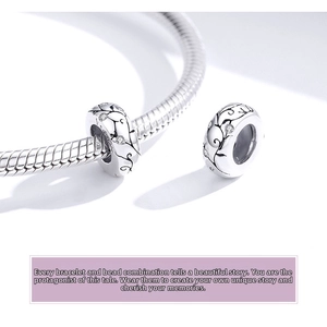 Detailed view of S925 sterling silver charm with floral engraving and sparkling crystals