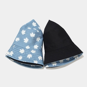 Reversible bucket hat for women with blue maple leaf print and solid black denim cotton