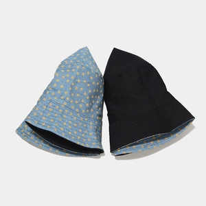 Detail of reversible denim bucket hat with floral print and black inner cotton lining