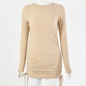Detail of adjustable side drawstrings and ruched hem on a ribbed knit mini dress