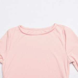 Close-up of pink ribbed fabric texture on a long sleeve crewneck bodycon dress