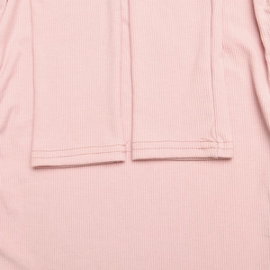 Close-up of pink ribbed knit fabric cuffs showing detailed double-needle stitching quality