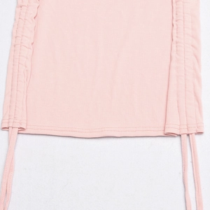 Detailed macro shot of the pink ribbed knit texture and adjustable drawstring hem design