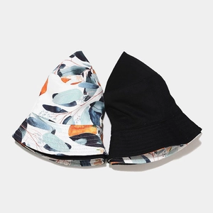 Reversible cotton bucket hat featuring orange fruit print and a classic black side