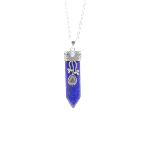 Lapis lazuli hexagonal pendant necklace with silver floral filigree detail on white background
