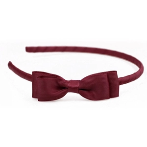 Detail view of burgundy grosgrain ribbon bow headband with fine textured fabric finish