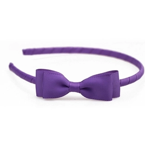 Detail showing the purple grosgrain ribbon texture and double-layered bow on headband