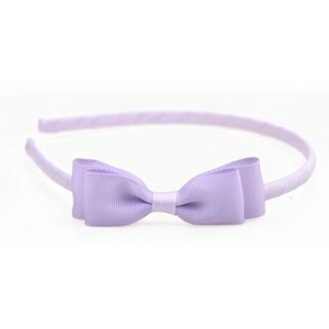 Detail of lavender grosgrain ribbon headband featuring a triple-layered bow on a white base