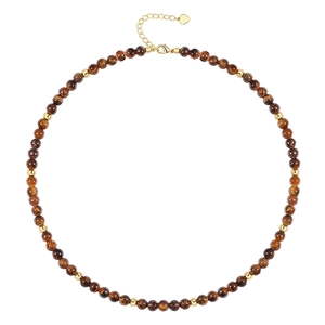 Detail of tiger eye bead necklace with gold lobster clasp and heart charm extension