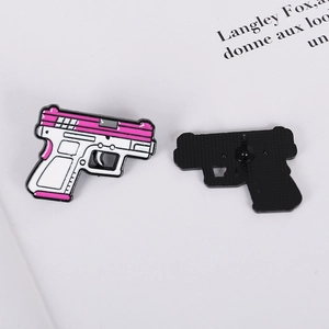 Front and back view of a creative pink metal enamel pistol brooch with a black butterfly clutch