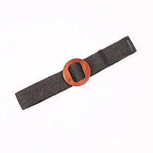 Dark gray straw woven belt with round wooden buckle for women on white background