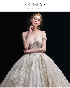 Close-up of off-shoulder wedding dress with intricate lace, sequins and beaded embroidery