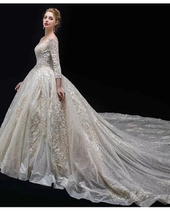 Side view of luxury champagne ball gown featuring long sleeves and exquisite sequins