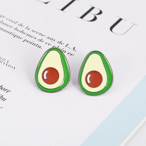 Vibrant avocado enamel earrings on a fashion magazine background with a 45-degree angle view