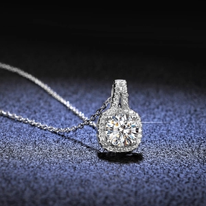 Macro shot of 1ct round moissanite silver pendant with halo stones and four-prong setting