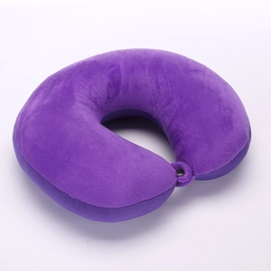 Detail view of the soft purple short plush U-shaped travel neck pillow on white background