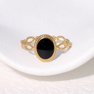 Vintage gold-plated stainless steel ring with oval black stone and twisted hollow band