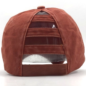 Detail view of brick red ponytail baseball cap showing the back messy bun elastic bands