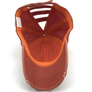 Detail view of cotton ponytail baseball cap featuring unique criss-cross back and inner seams
