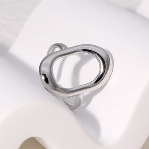 Minimalist silver geometric hollow oval stainless steel ring on aesthetic white display