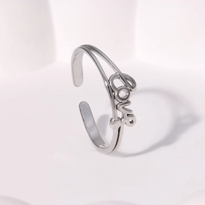 Macro detail of silver double-layered open ring featuring an artistic Love lettering design