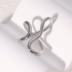 Macro detail of silver abstract criss-cross line ring with a polished minimalist finish