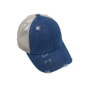 Distressed denim baseball cap with beige mesh and criss-cross ponytail hole design