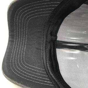 Close-up of a warm cashmere baseball cap with multi-row stitching on the grey brim