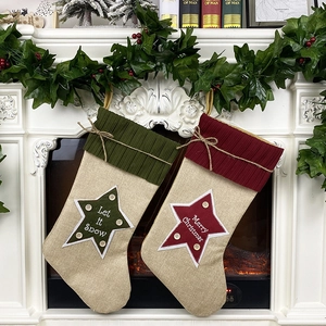 Linen Christmas stockings in red and green with star patches and festive embroidery