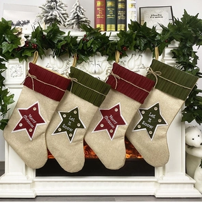 Linen Christmas stockings with knit cuffs hanging on a cozy white fireplace mantel