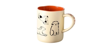 Cream ceramic dog illustration coffee mug with vibrant orange interior and stylish handle
