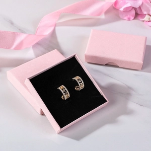 Gold-plated star earrings with crystals and letter engraving in a pink gift box