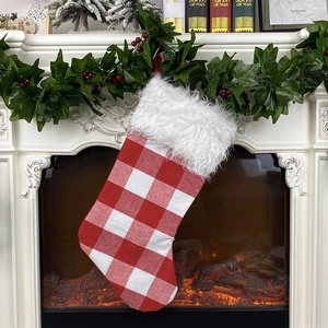 Classic red and white plaid Christmas stocking with plush cuff in a cozy holiday setting