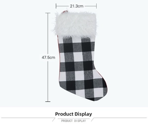 Detail of Christmas stocking with black white plaid fabric and white faux fur cuff trim